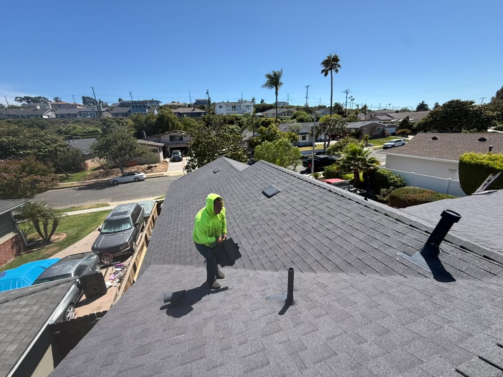 Roofing contractor inspecting a tile roof for California home insurance compliance